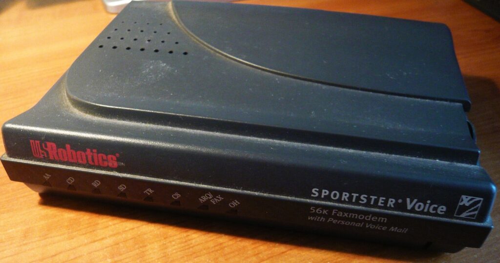 A beige US Robotics 56K external dial-up modem viewed from the front, with a row of status lights.