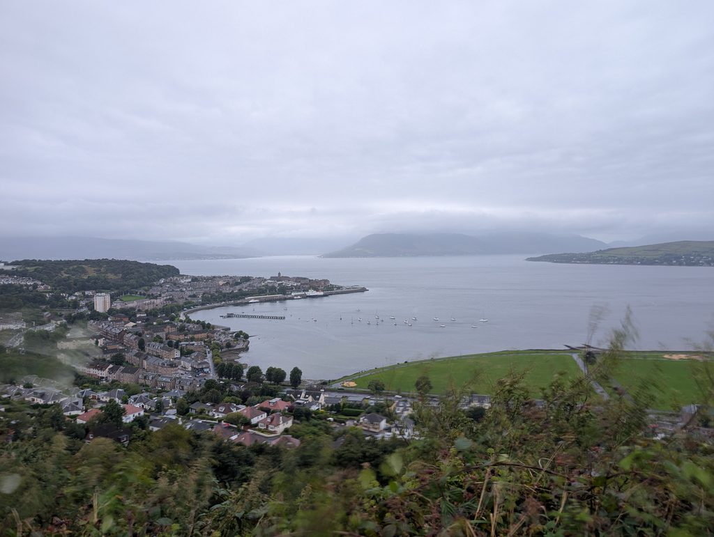 Wide view over the Firth of Clyde from Lyle Hill, with Gourock waterfront below and hills fading into mist